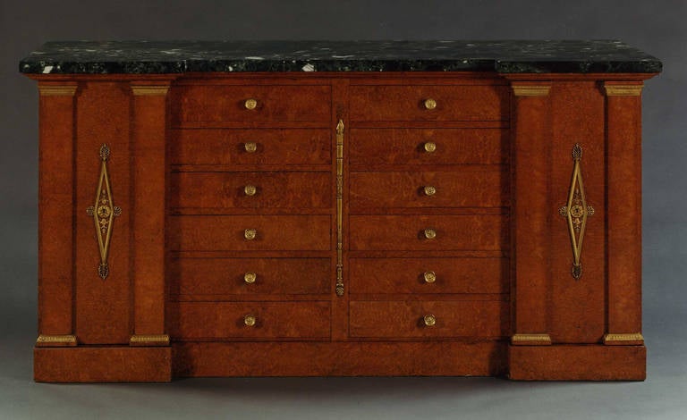 French Empire style (circa 1860) amboyna wood & gilt bronze mounted cabinet with a Pair of side doors securing and centering 6 Pair of drawers under a dark green marble top.
