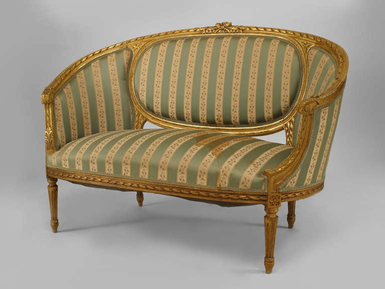 Französischer Louis XVI-Stil (19/20. Jh.), vergoldeter Sessel mit geschnitzter ovaler Rückenlehne und grün gestreifter Polsterung
