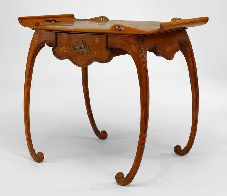 French Art Nouveau walnut and floral inlaid serving table on scroll legs with a tray form top having open handles and filigree gallery corners with a drawer (signed EMILE GALLE)
