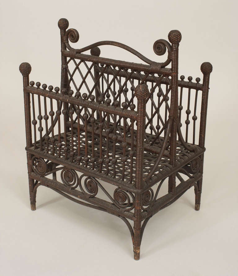 American Victorian dark stained natural wicker magazine rack with spindle & scroll design and a woven bottom with small ball finial. (remnants of a HAYWOOD WAKEFIELD label)
