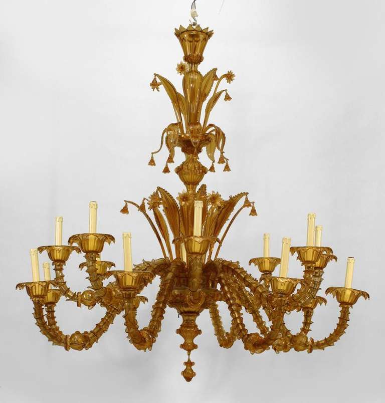 Late nineteenth century amber murano glass chandelier by Venetian designer Salviati. The chandelier's stem is composed of three tiers of flared glass bobeches in the form of blossoming leaves and petals, each suspending a small floral-shaped bell.