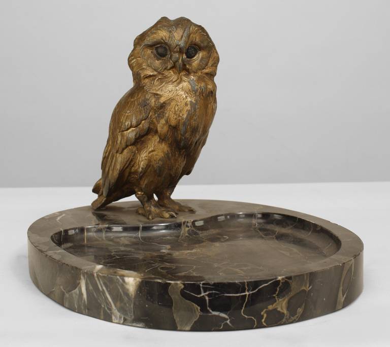 Early twentieth century French gilt metal ashtray with an owl propped atop a black marble oval base.