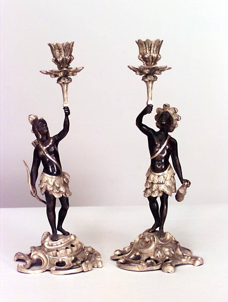 Pair of French Louis XV-style (20th Century) bronze and dore trimmed candlesticks of Indians in traditional dress with one holding a bow & arrow and the other a club (PRICED AS Pair)
