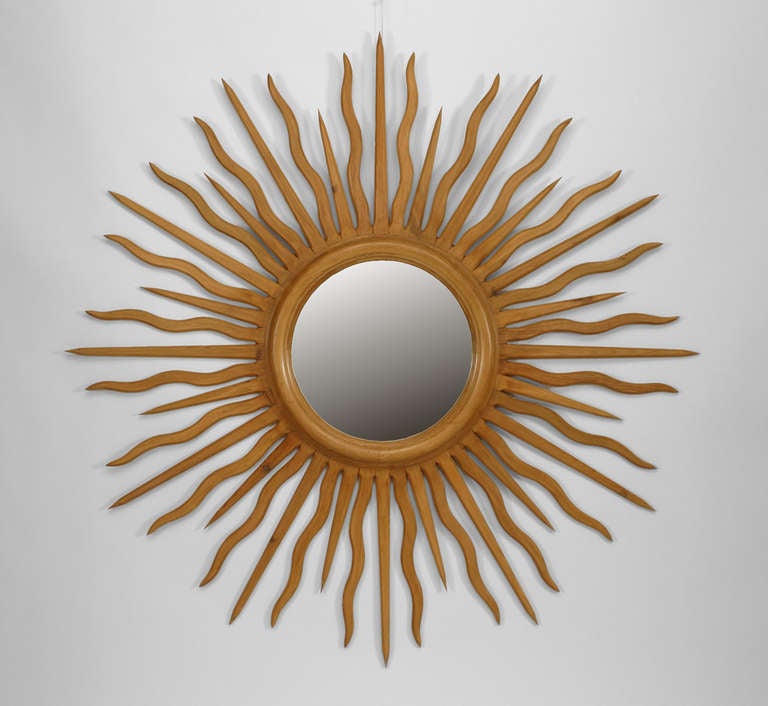 1940's French sunburst form wall mirror with round convex mirrored glass centers surrounded by a series of giltwood rays.