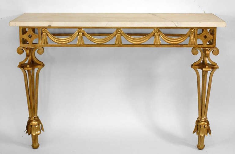 1940's bracket console table attributed to French designer Gilbert Poillerat. The console features a gilt wrought iron base  with two open design legs supporting a white marble top and
swag design apron.