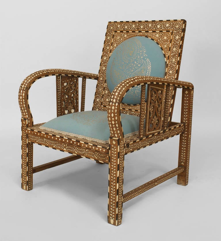 Anglo-Indian (19/20th Cent) teak arm chair with inlaid design having a blue upholstered seat and round back panel with filigree side arm panels. NOTE: seat height 14