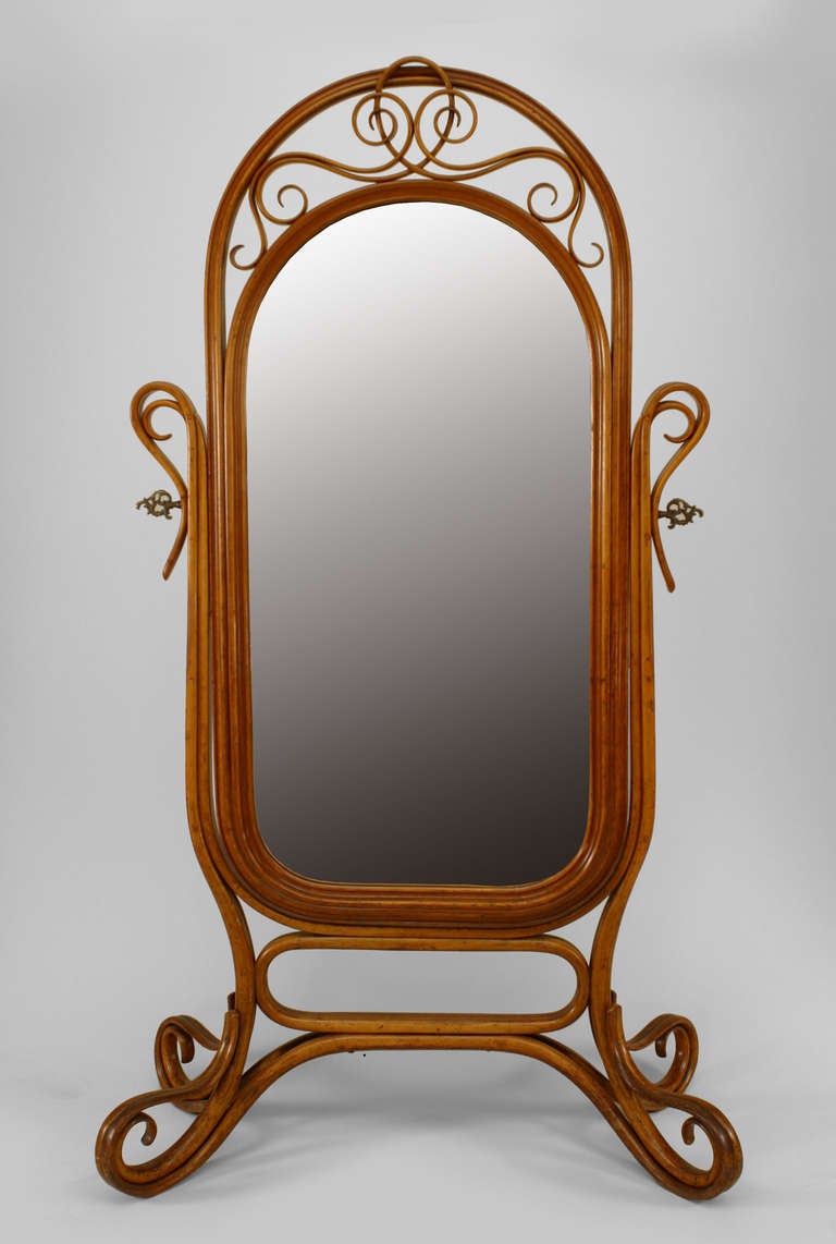 Bentwood (19th/20th Century) light oak cheval mirror with ornate pivot screw supports.
