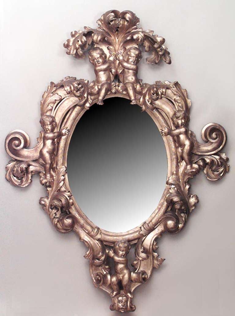 French Victorian monumental giltwood vertical wall mirror with cupid and scroll carving.
