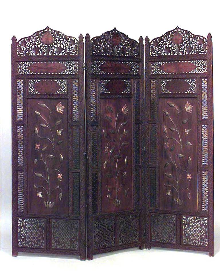 Nineteenth century Middle Eastern carved folding screen with three carved teak panels, brass and copper floral designs, and filigreed tops and sides.