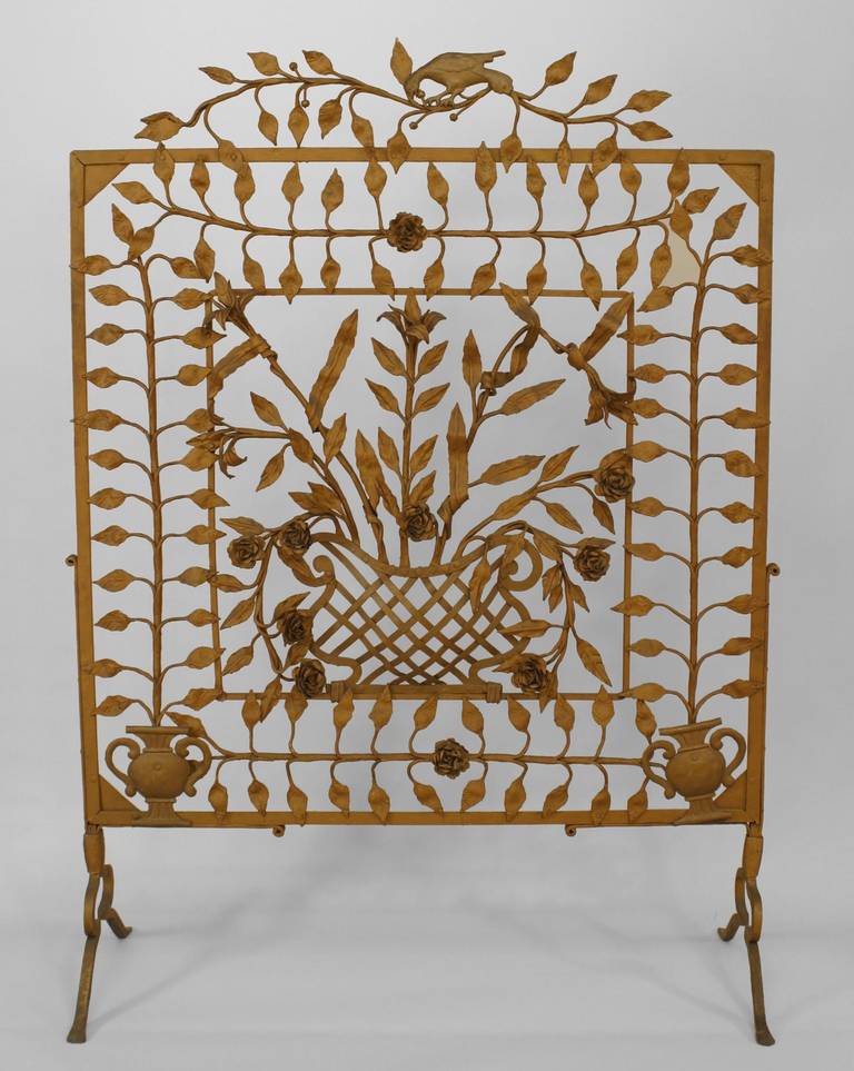American Victorian painted wrought iron large filigree fire screen with floral design of leaves and flowers with a figure of a bird on top.
