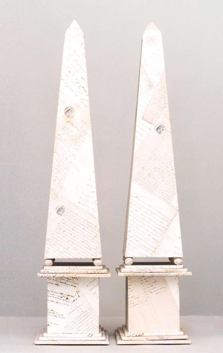 Pair of French Mid-Century-style (1940s) white parchment veneered obelisks with script decoration (PRICED AS Pair)
