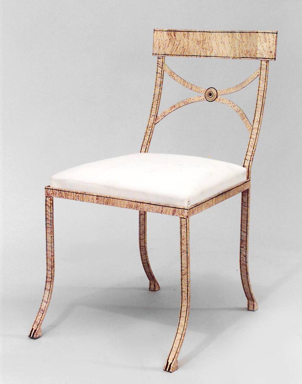 Twentieth century English Regency style faux maple painted iron side chair with open design backs and slip seats.

