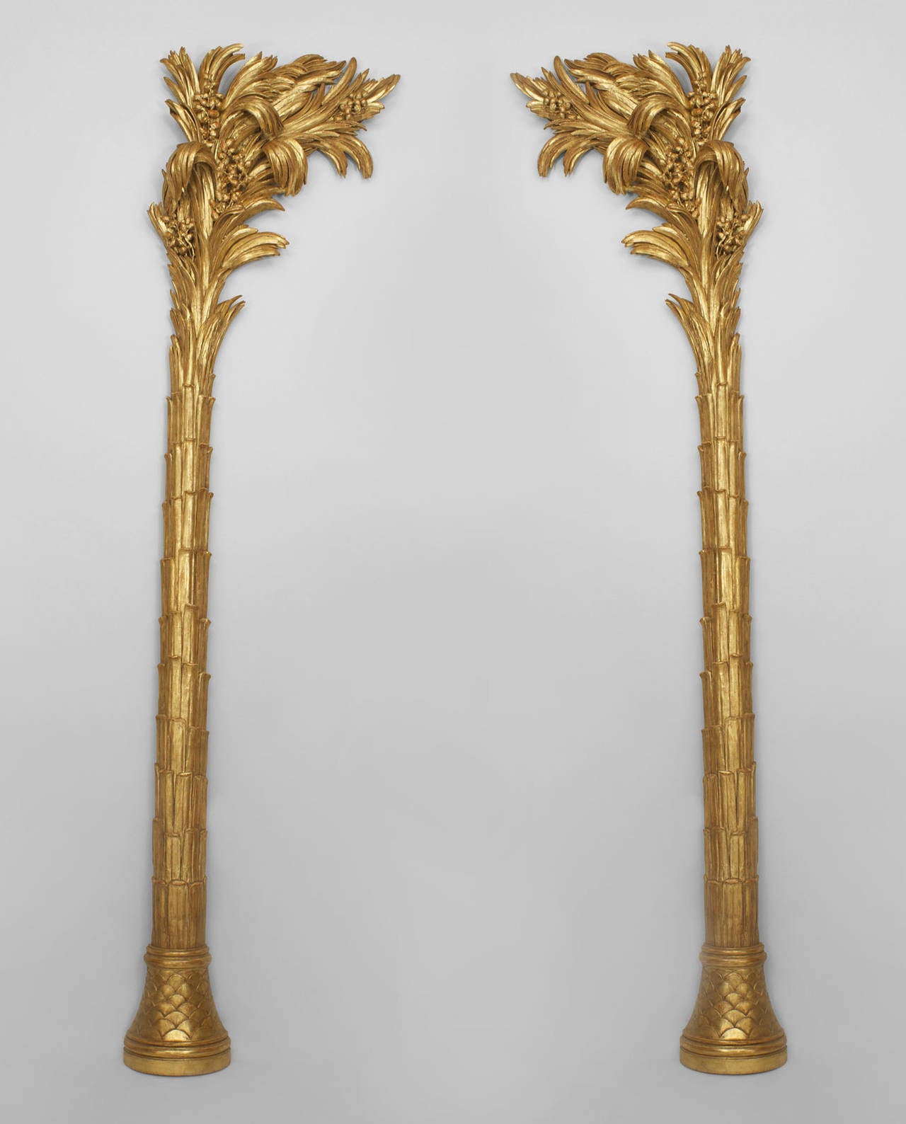 Pair of eighteenth century Northern Italian left and right gilt carved palm trees with later carved bases.