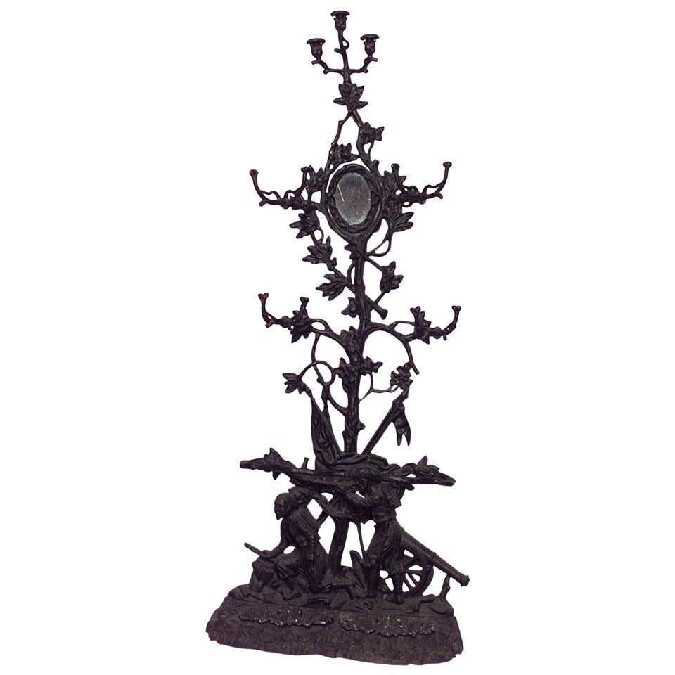 French Victorian wrought iron hatrack with 2 figures at base with mirror and candelabra on top (signed CORNEAU FRERES, Charleville)
