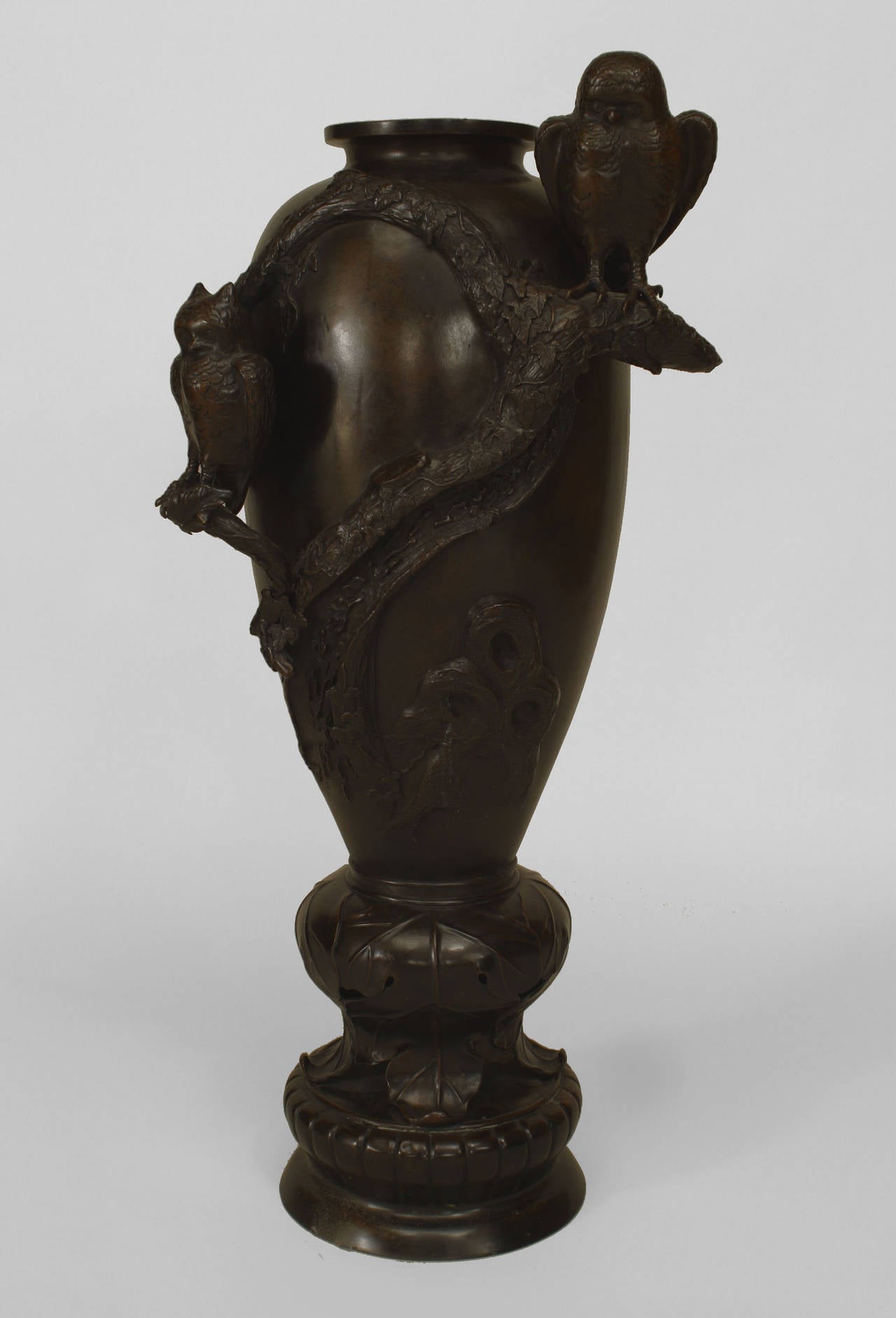 Asian Japanese bronze floor vase with 2 owls figures standing on branches with a leaf relief around a round base.
