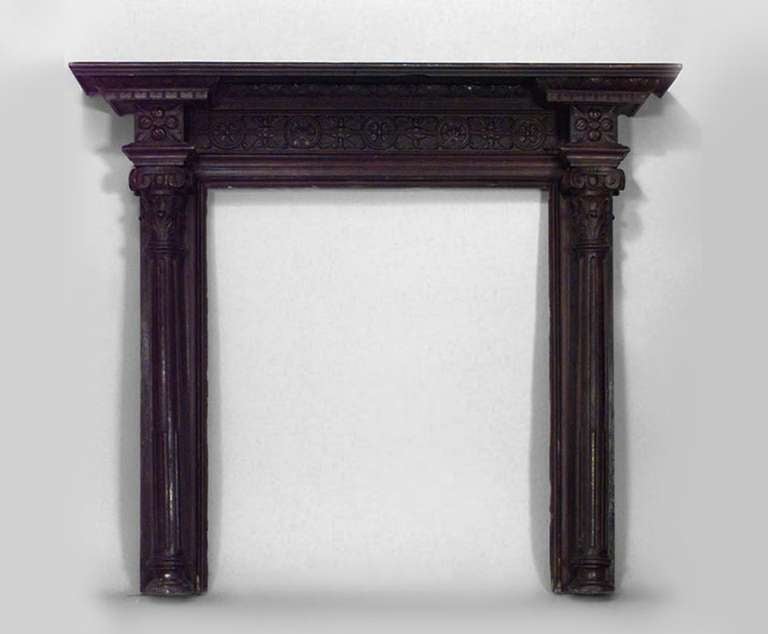 English Georgian style dark stained oak mantelpiece carved in a rectilinear post and lintel composition referencing both Classical architecture and traditional English iconography. Specifically, each side is adorned with composite ionic and