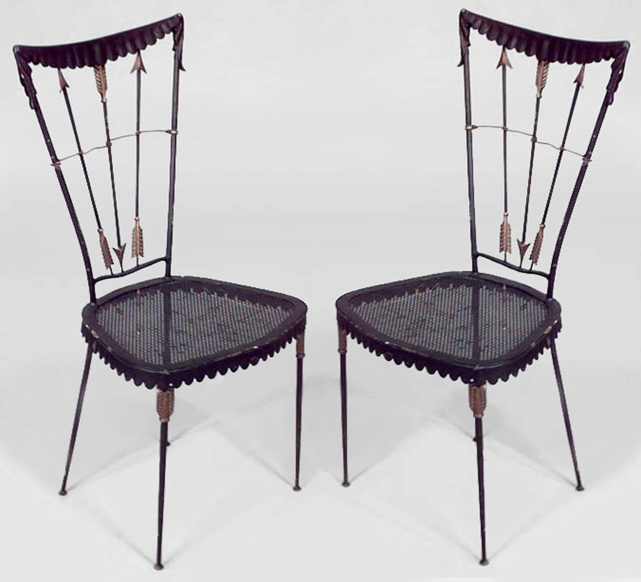 Pair of 1940's French black-painted metal side chairs with arrow design backs and perforated seats over four thin splayed legs.