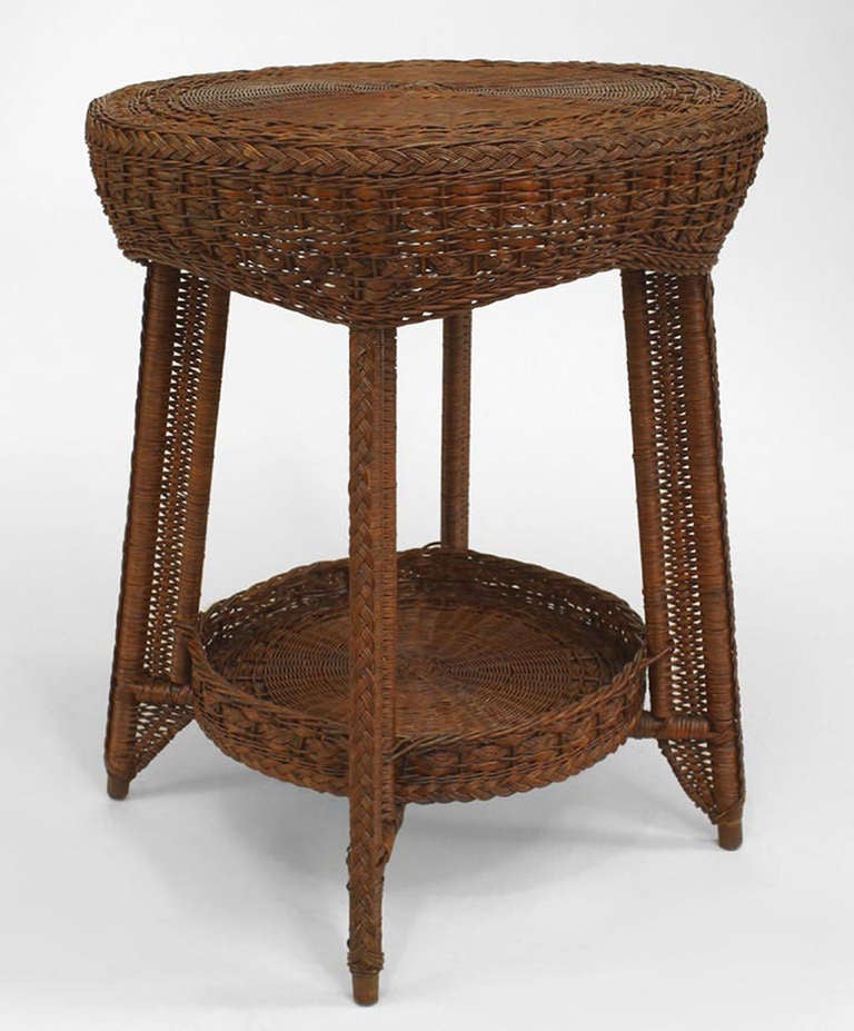 Attributed to the noted American Heywood Brothers, this nineteenth century American this round end table is composed of natural wicker with a woven apron and lower shelf gallery.