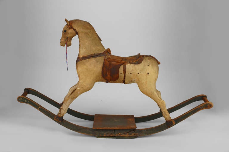 19th century American parchment veneered hobby horse supported by a green painted and decorated rocker base.