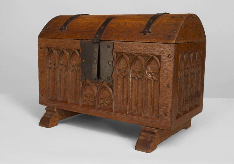 French Gothic-style (19/20th Century) oak coffer chest on stand with tracery carved panels and a domed lid with iron strap work
