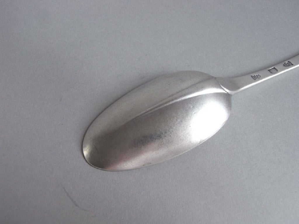 The Spoon is modelled in the Hanoverian Rat Tail design. The top of the stem is engraved with a set of contemporary scratch engraved initials and the front with the inscription 