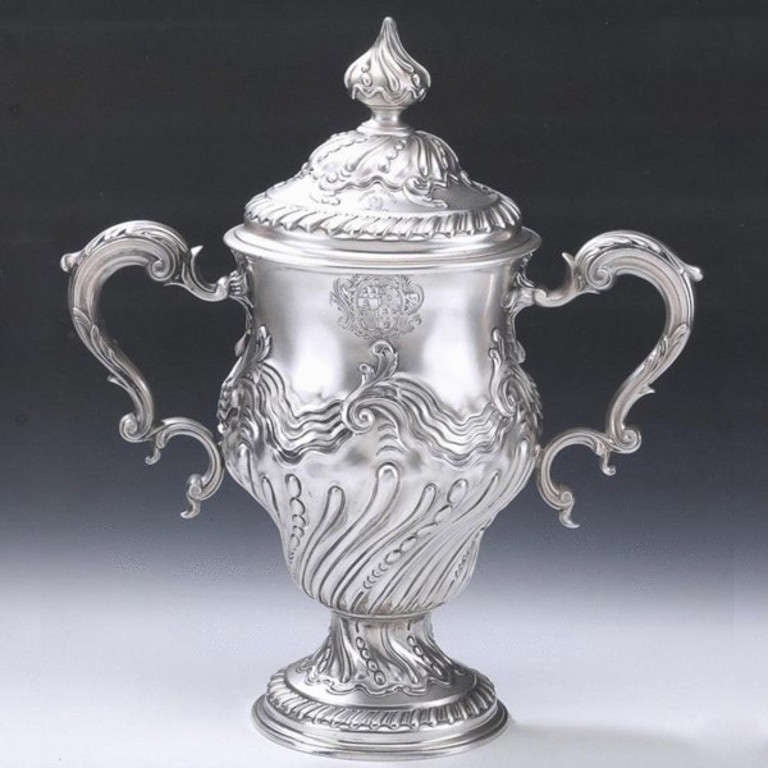 THE FARLEY CASTLE CUP

The Cup stands on a stepped pedestal foot which is decorated with a band of gadrooning, as well as swirl fluting and beading.  The slightly baluster main body is also decorated with swirl fluting and bold beading, in