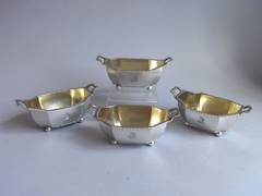 A set of four Salt Cellars, modelled as carrying baskets, made by Henry Nutting.