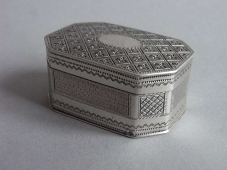 A fine George III Pocket Nutmeg Grater made in London in1806 by Thomas Phipps & Edward Robinson. 

The Nutmeg Grater is broad rectangular in form with cut corners. Both the cover and base are engraved with unusual diamond motifs containing flower