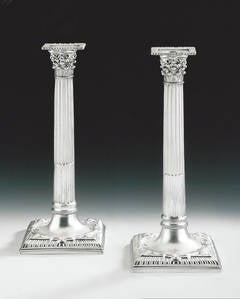 A fine pair of George II cast Corinthian Column Candlesticks made by Robert Rew.
