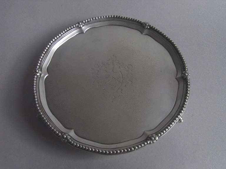 The Salver stands on four claw and ball feet and displays a raised beaded rim interspersed with flower heads. The centre of the main body is engraved with a contemporary Armorial surrounded by a floral cartouche. Very well marked on the reverse.