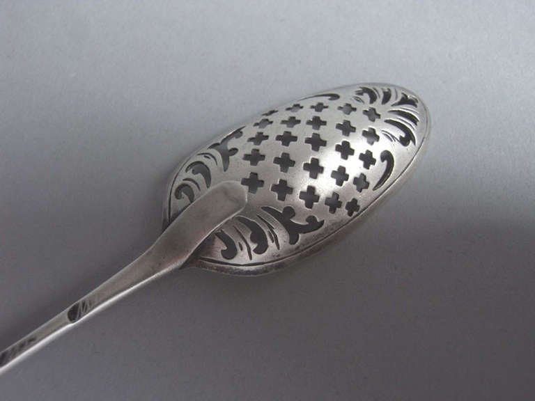 The Mote spoon is finely pierced with crosses and scrolls and the reverse of the bowl is engraved with linear designs. 
Measures: Length: 5.8 inches.