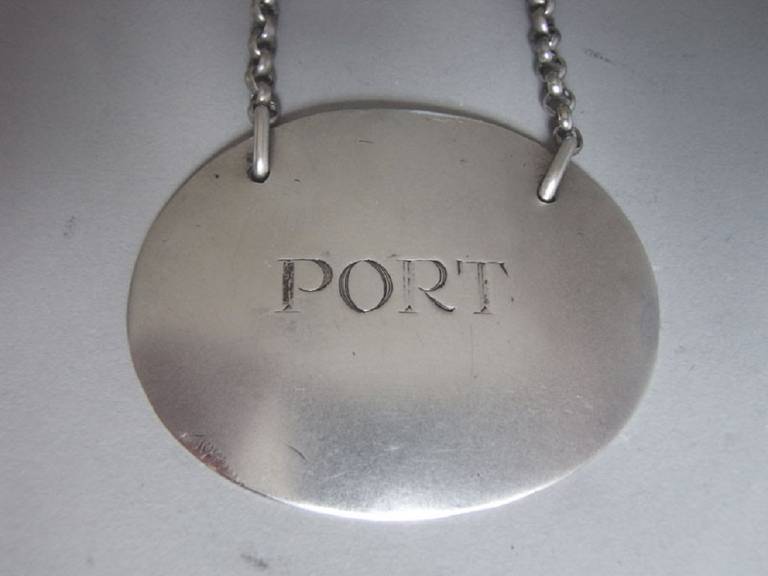 The label is unusually modelled as a large plain disc and is engraved for Port. This piece also has an exceptionally long chain. This is the first time we have seen this rare design. 

Measures: Length: 2.5 inches, 6.25cm. 
Width: 2 inches, 5cm.