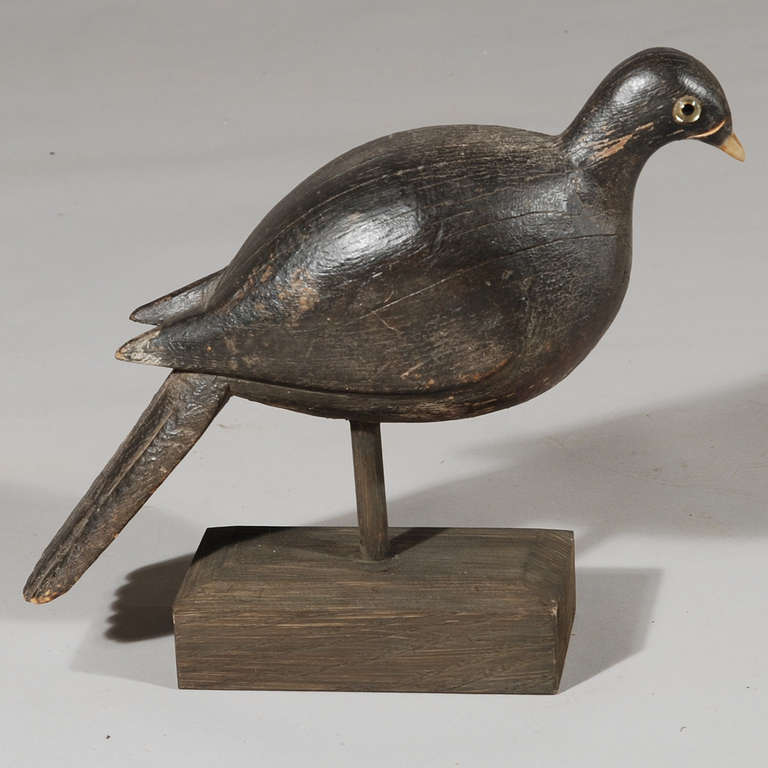 An early 19th century carved decoy pigeon with original paint finish.