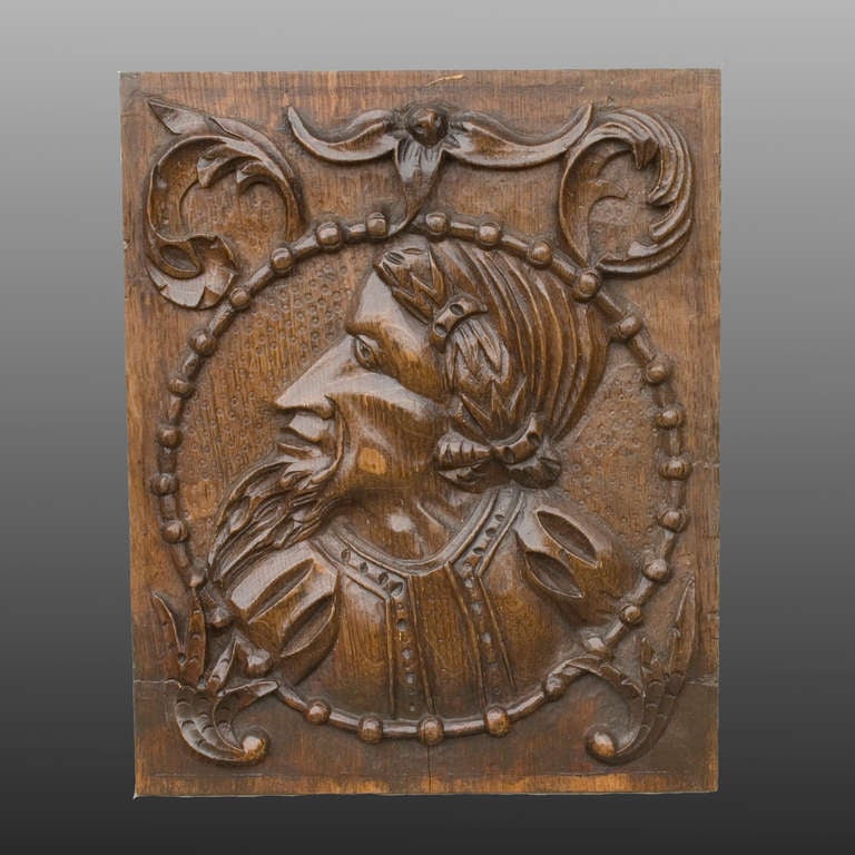 A good 16th century relief carving in oak of a bearded nobleman with laurel wreath.