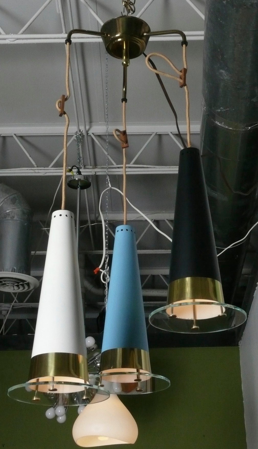 Late 50s 3 pendant adjustable height fixture with enameled metal & brass cones that support glass discs. It has a 35