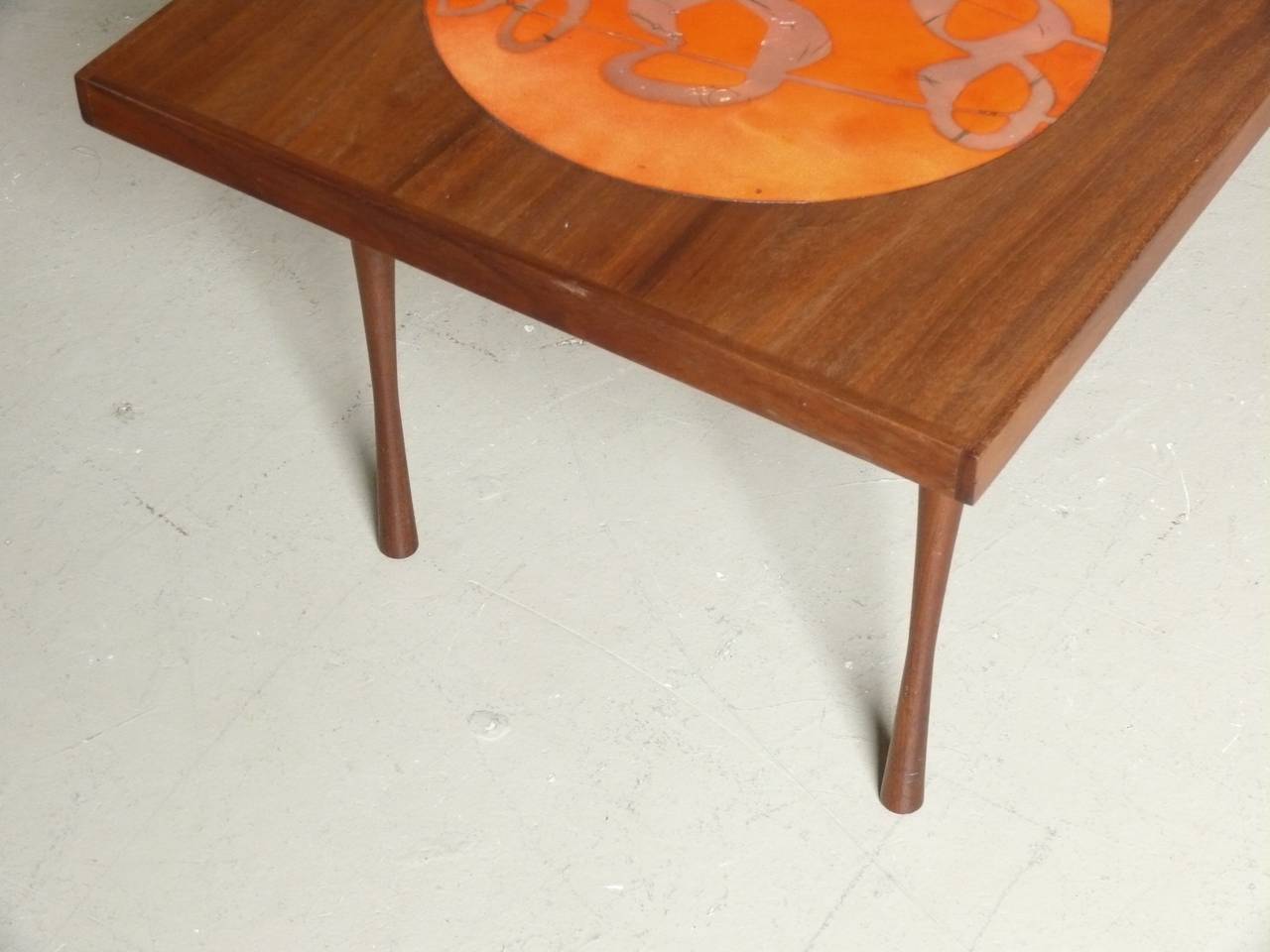 1960s beautifully grained walnut coffee table with 4 small & 1 large enamel over copper inset disks & tapered hourglass style legs.
Small disks- 1.5