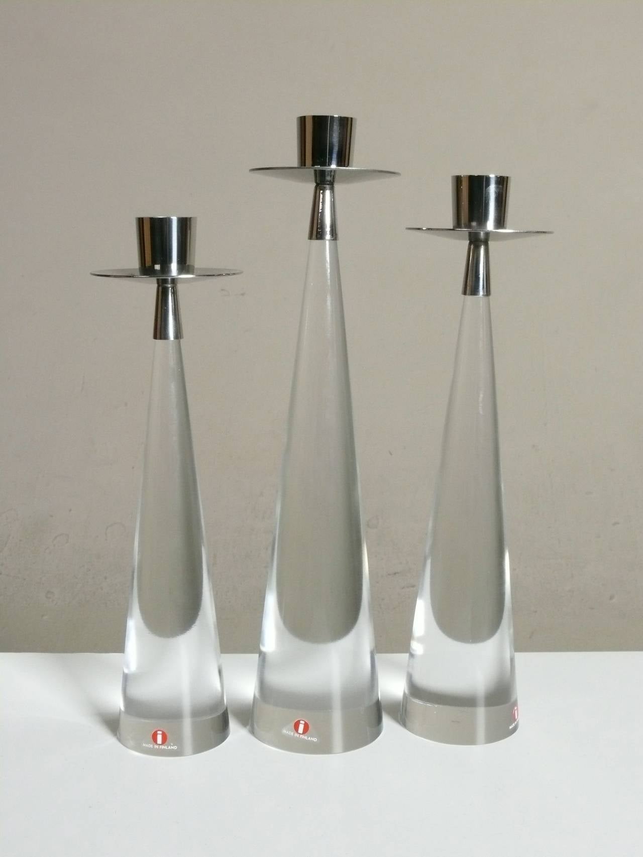 Rare modernist trio of candle holders by Tapio Wirkkala for Iittala in glass and stainless, each retaining its original Iittala label.