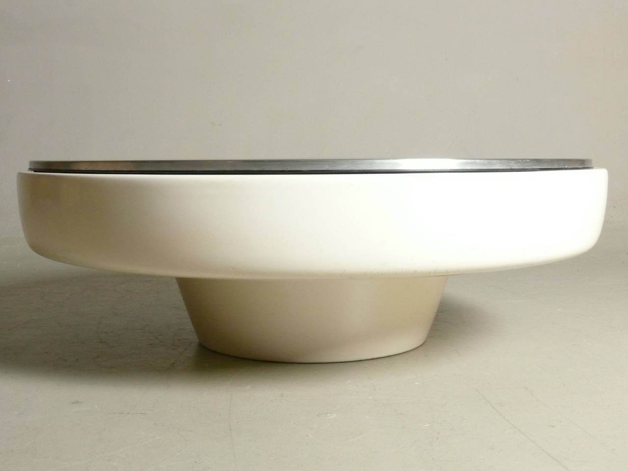 1970s coffee table with a  lacquered fiberglass base & a removable stainless steel top.