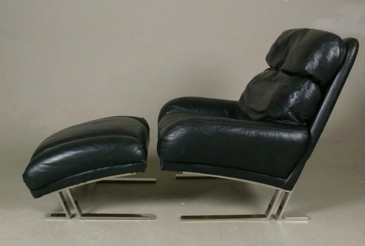 Vintage large scale black leather and chrome lounge chair and ottoman by Milo Baughman for Directional.