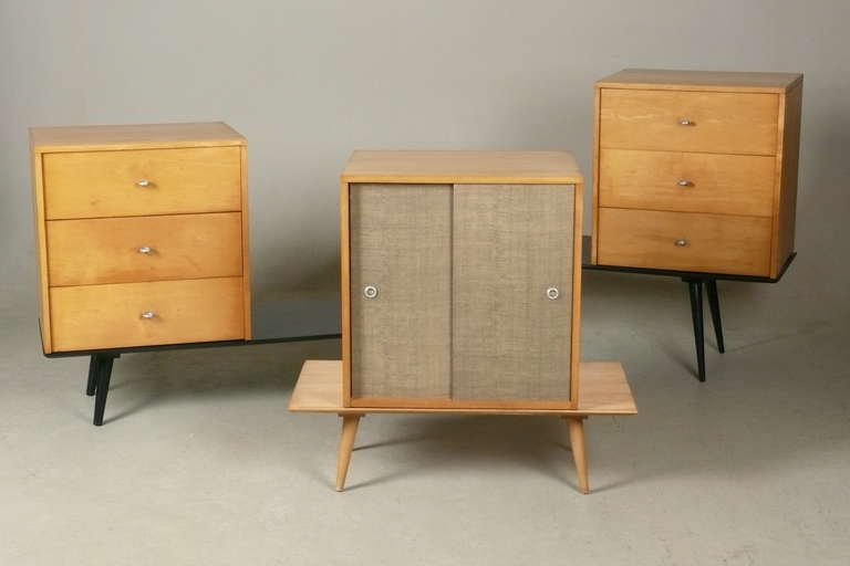 Group of early Paul McCobb Modular furniture from his Planner Group Line. All pieces are solid maple. Two benches have a new satin black finish. All pieces have been restored.The three chests bear the early brand style mark and the natural bench has