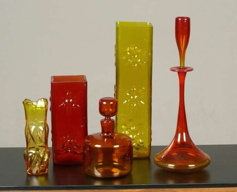 A stunning collection of 1960s, blown glass vases and decanters all designed by Wayne Husted for Blenko.  
From left to right:
Triangular form vase, 8