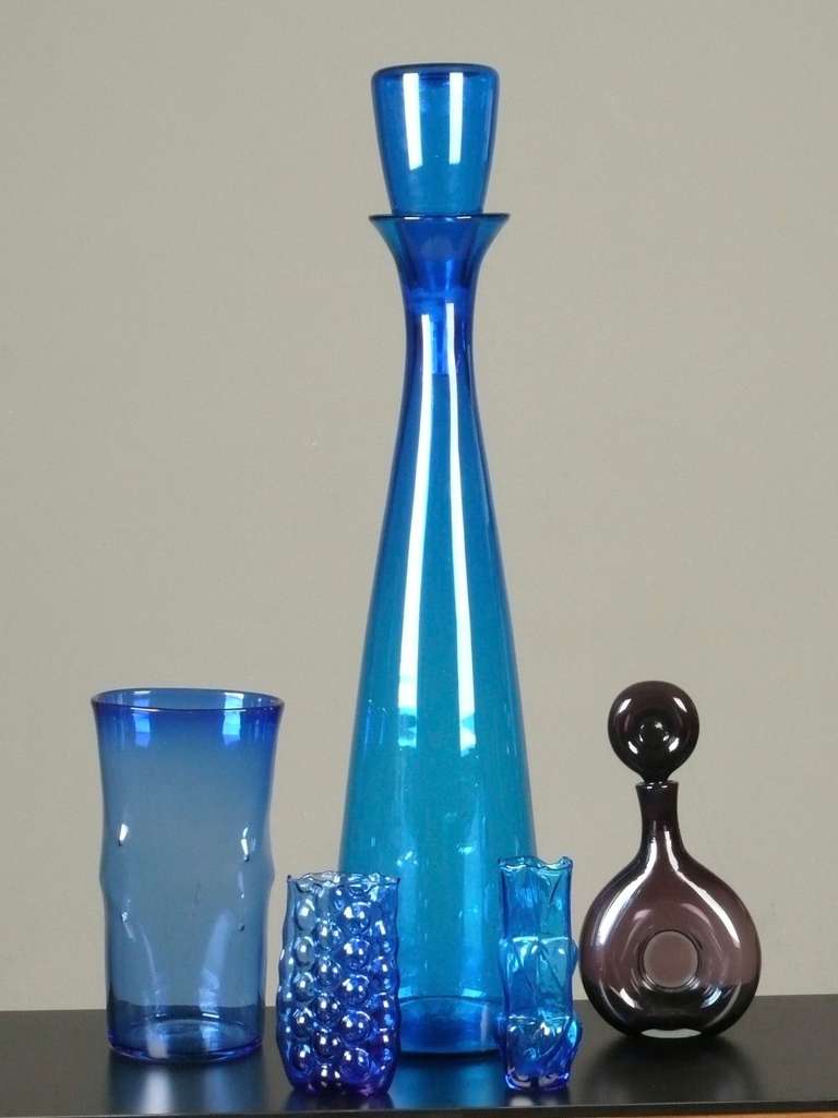 A collection of 1960s,  blown glass vases and decanters designed by Wayne Husted for Blenko.  
From left to right:
Tall dimpled vase, early 1960s, 13