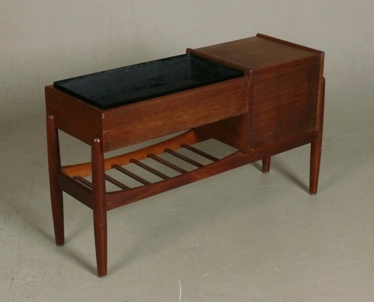 Early 1960s console table in teak with three small drawers, a planter box and lower magazine shelf designed by Arne Wahl Iversen for Vinde Mobelfabrik, Denmark.