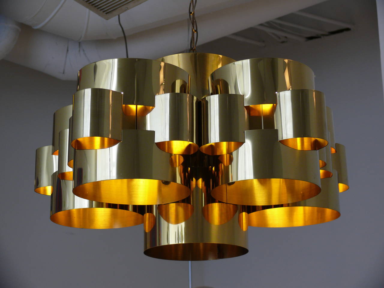 Stunning stacked brass ring chandelier by Curtis Jere, circa 1973. Commonly referred to as the 
