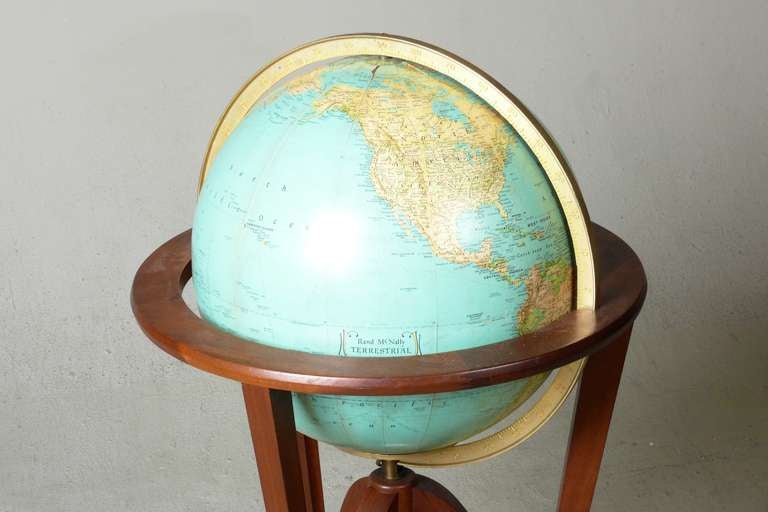 Illuminated globe designed by Edward Wormley for Dunbar.  Globe sits on a solid walnut stand with brass feet.  Globe measures 16