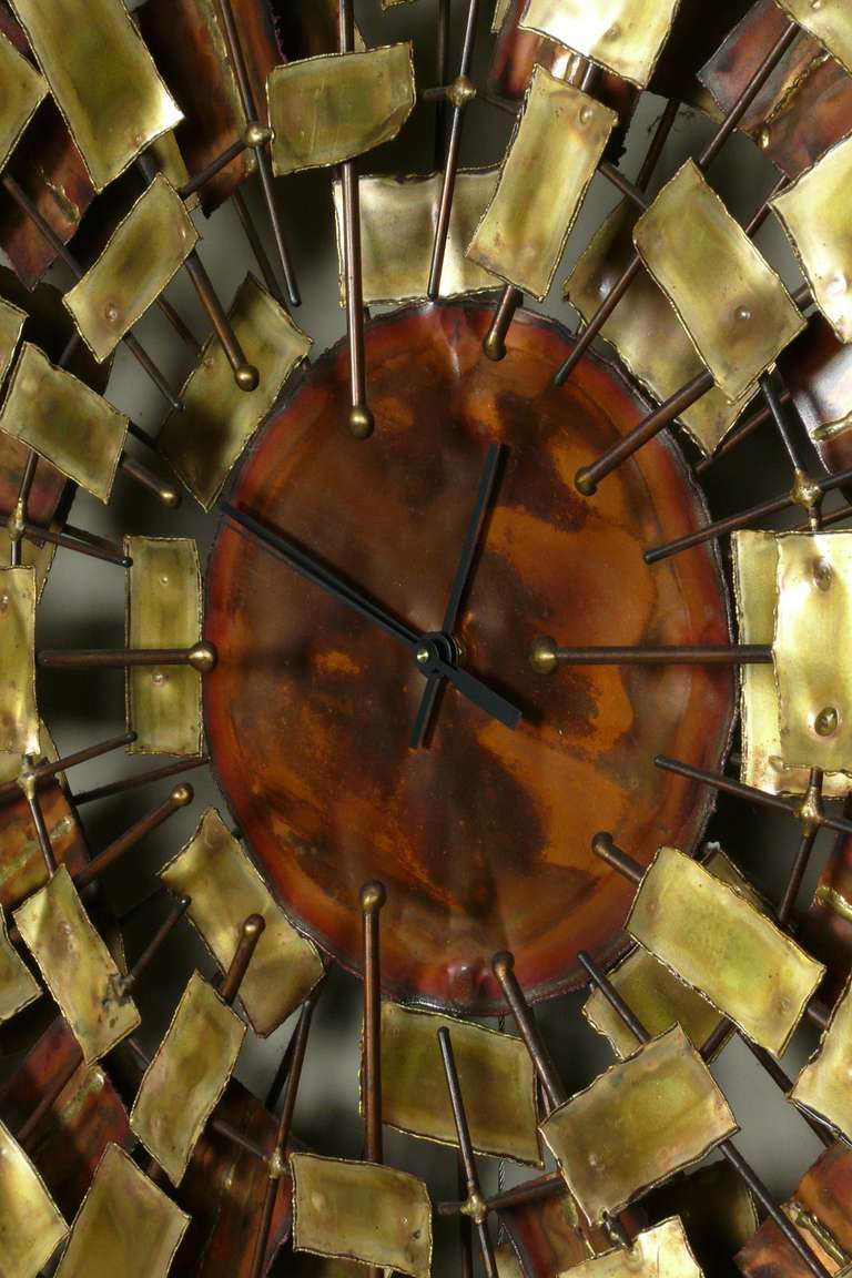 Large 1960's brutalist style copper & brass wall sculpture clock signed Simmons. The copper face looks great. The glare in the photos is deceiving. The original D Cell battery clock works has been replaced with an Atomic works that keeps perfect