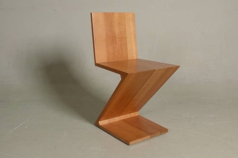 C. 1990 example of Gerrit Rietveld's classic Zig Zag chair in cherry wood made by Cassina.  Stamped and numbered on base and retains original Cassina hang tag.