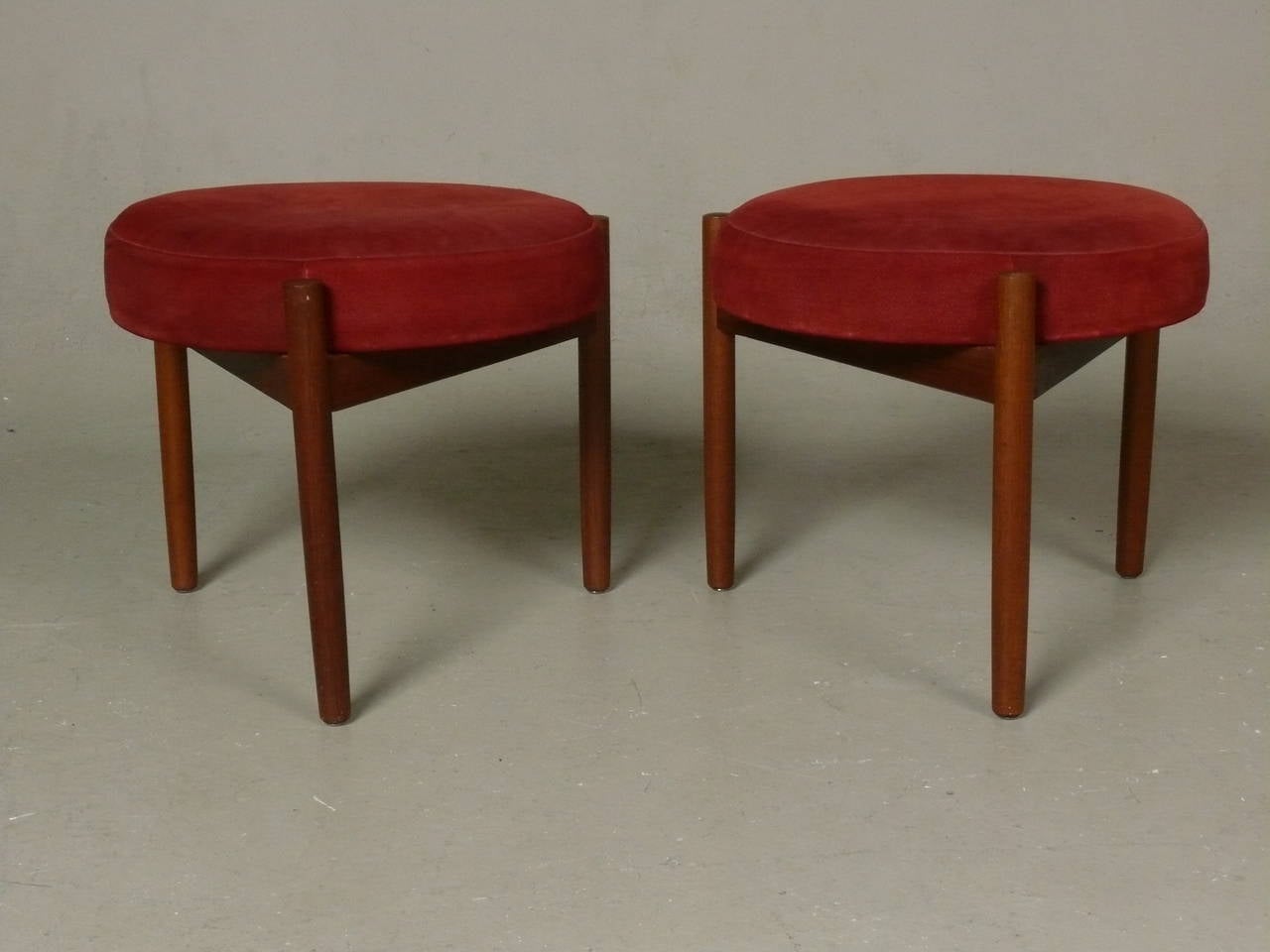 Vintage teak frames footstools with original red suede upholstery, made in Denmark, circa 1970.