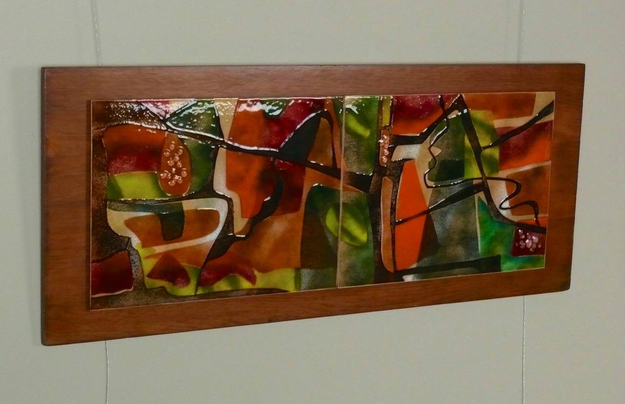 Beautifully done 1960s wall art consisting of 2 abstract enamel over copper plaques mounted to a walnut panel.