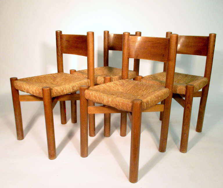 Set of four Méribel chairs manufactured by Georges Blanchon for the Méribel-les-Allues resort in France c. 1948. 

Solid oak frame with rush seat.